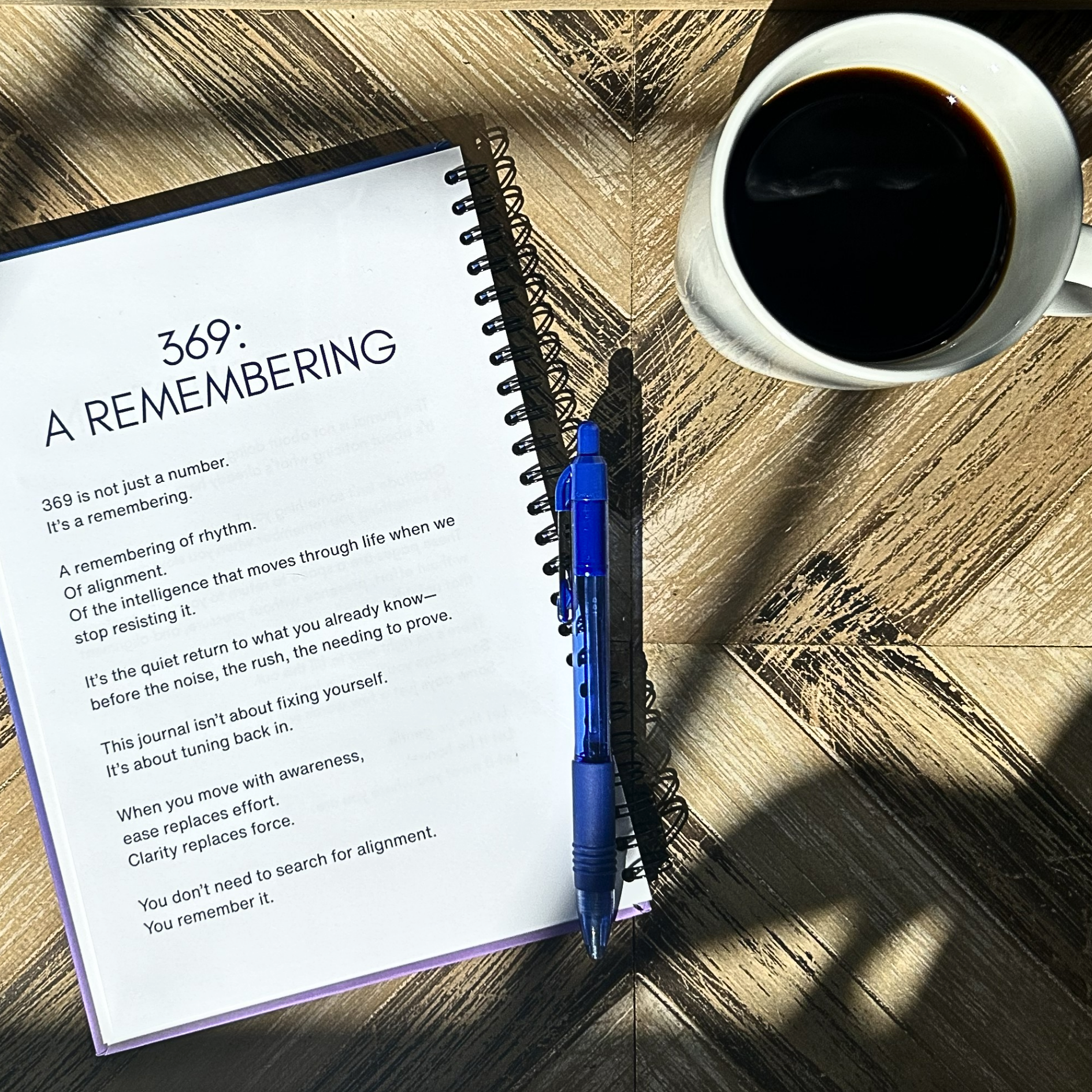 Open gratitude journal pages with prompts on wooden table beside coffee and pen Level 369