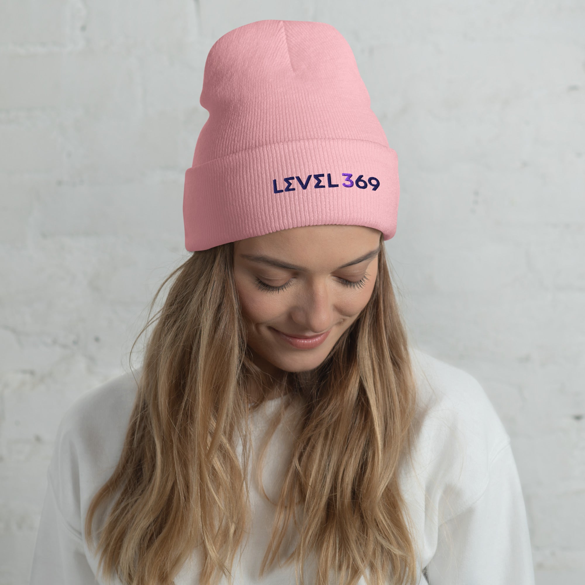Pink beanie featuring the logo 'Level 369.'