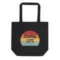 Black eco tote bag featuring the phrase ‘Enjoy Life’ in a retro sunset color palette.