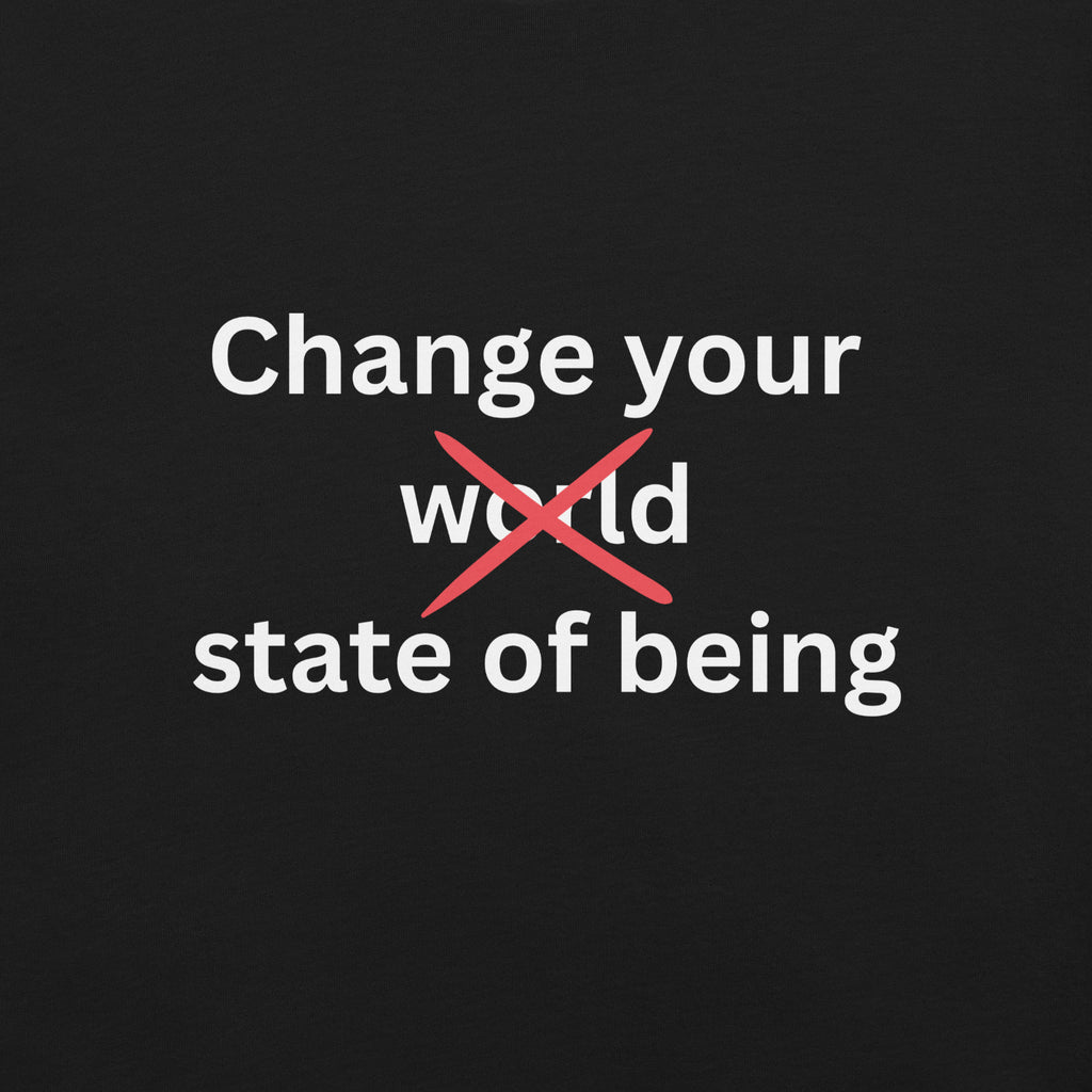 Close-up of a black minimalist t-shirt featuring the phrase “Change your state of being” in white typography with the word “world” crossed out in red.