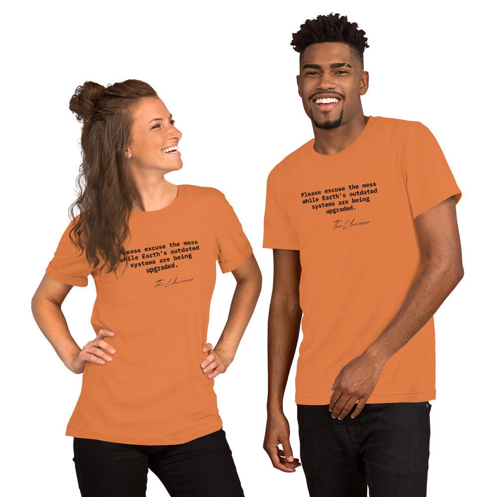 Burnt orange unisex t-shirt featuring the phrase 'Please excuse the mess while Earth’s outdated systems are being upgraded.'