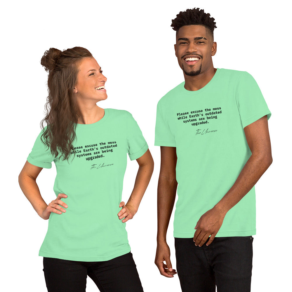 Mint green unisex t-shirt featuring the phrase 'Please excuse the mess while Earth’s outdated systems are being upgraded.'
