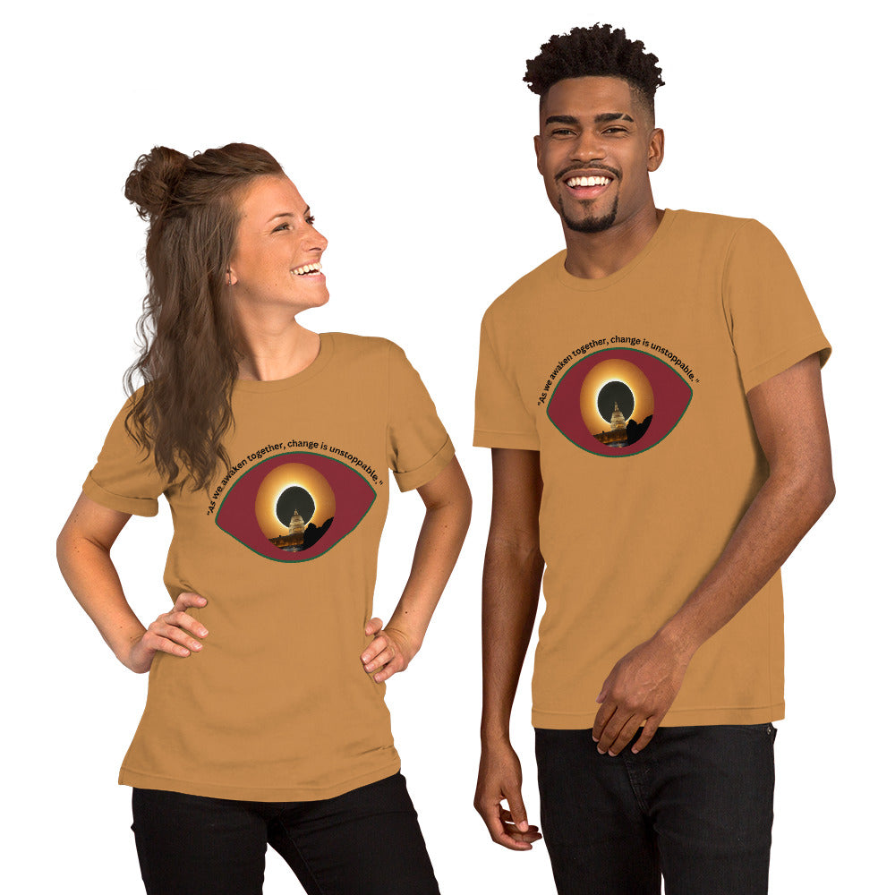 Light brown unisex t-shirt featuring the phrase “As We Awaken Together."