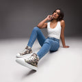 Camouflage women’s high-top canvas shoes with modern streetwear design.
